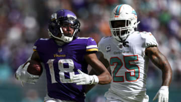 MIAMI GARDENS, FL - OCTOBER 16: Justin Jefferson #18 of the Minnesota Vikings carries the ball as Xavien Howard #25 of the Miami Dolphins chases during the third quarter of an NFL football game at Hard Rock Stadium on October 16, 2022 in Miami Gardens, Florida. (Photo by Kevin Sabitus/Getty Images)